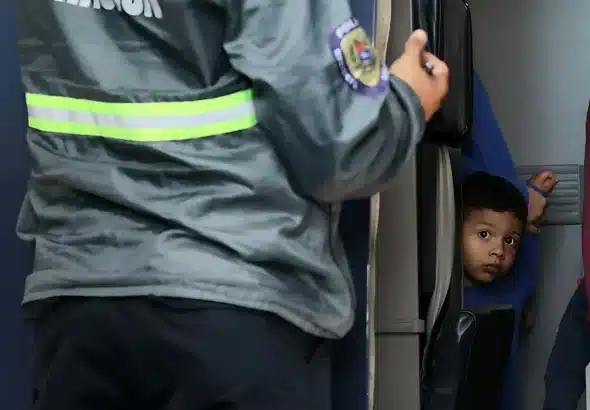 A repatriated Venezuelan child looking curiously outside the aircraft arriving at Venezuela on Friday, August 1, 2025. Photo: IG/@minjusticia_ve.