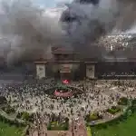 Protesters celebrate at the Singha Durbar, the seat of Nepal's government various ministries and offices after it was set on fire during a protest against special media ban and corruption in Kathmandu, Nepal, Tuesday, Sept. 9, 2025. Photo: Prakash Tiimalsina/AP.