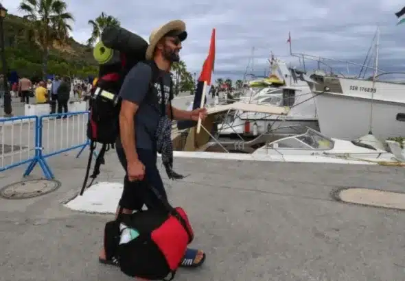 A member of the Global Sumud Flotilla entering the marina in Barcelona, Spain. Photo: AP.