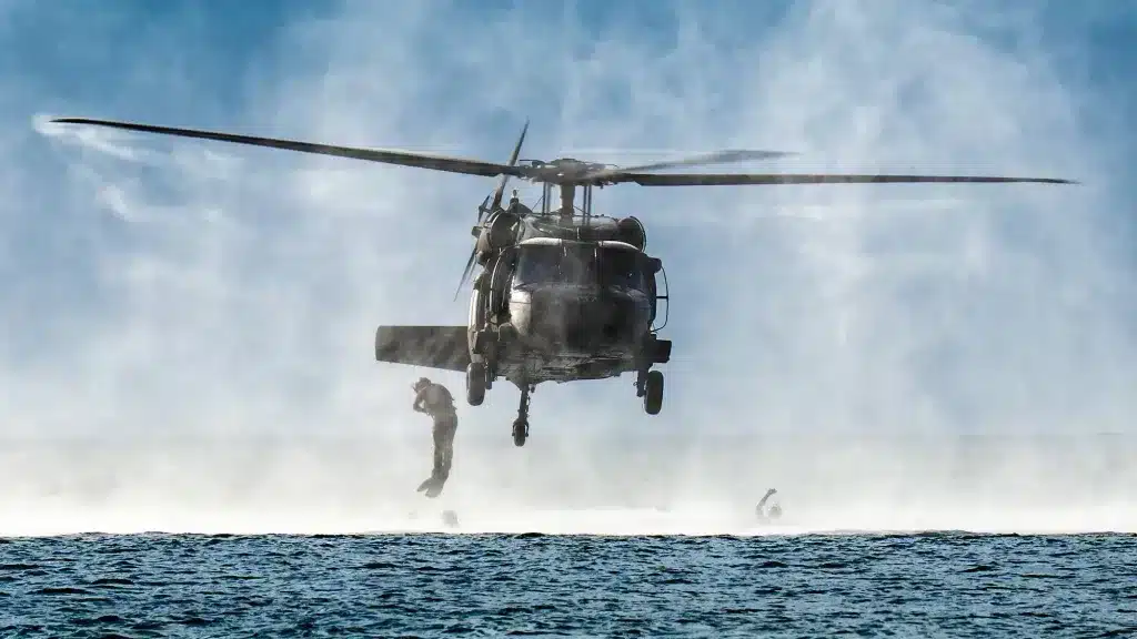 A US Sikorsky UH-60 Black Hawk helicopter conducting maritime operations with a special tactics airman descending into the water. Photo: US Air National Guard/file photo.