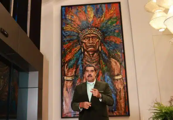 President Nicolas Maduro standing in front of a painting. Photo: Presidential Press.