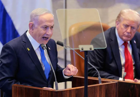 the photo captures a moment during a special session of the Knesset, Israel's parliament, where Israeli Prime Minister Benjamin Netanyahu addressed the assembly while former U.S. President Donald Trump was present. The event took place on October 13, 2025, in Jerusalem.