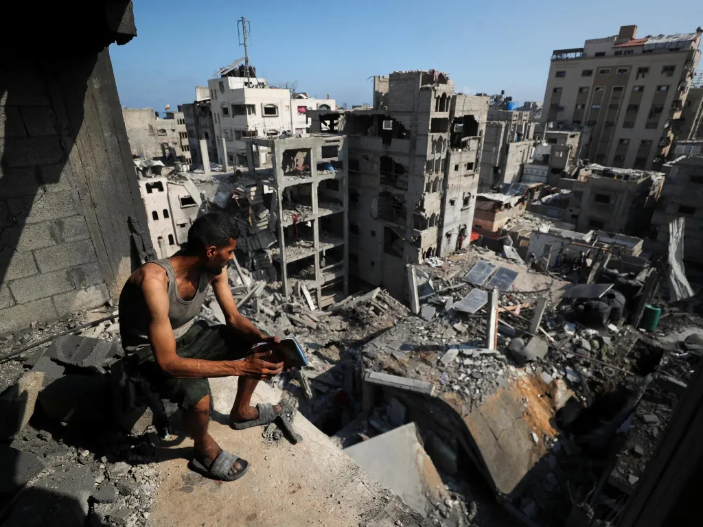 A Palestinian man looks on at the site of an Israeli strike in September 2025 that massively destroyed residential buildings. Photo: Mahmoud Issa/Reuters/file photo.