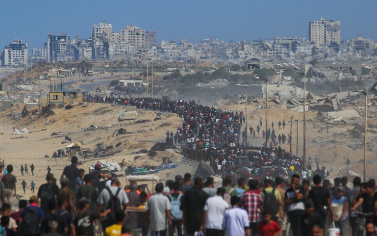 Palestinians walk along Al-Rashid Road toward scorched-earth Gaza City from Nuseirat in the central Gaza Strip, on October 10, 2025. Photo: Bashar TALEB/AFP.