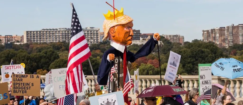 A "No Kings" protest in Washington D.C. on October 18, 2025, that was part of a larger series of nationwide protests against the US regime. The demonstration features an effigy of Donald Trump wearing a crown and a cape, carried by a protester. Photo: Tom Hudson/Zuma Press Wire/Shutterstock.