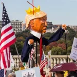 A "No Kings" protest in Washington D.C. on October 18, 2025, that was part of a larger series of nationwide protests against the US regime. The demonstration features an effigy of Donald Trump wearing a crown and a cape, carried by a protester. Photo: Tom Hudson/Zuma Press Wire/Shutterstock.