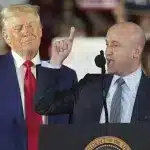 US President Donald Trump listens while White House Deputy Chief of Staff Stephen Miller speaks in Warren, Michigan, April 29, 2025. Photo: AP/Paul Sancya.