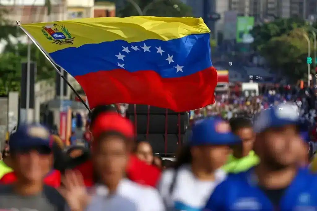 A big Venezuelan flag being waved by a marcher in Caracas demanding United Nations to prevent a US military aggression against Venezuela. October 6, 2025. Photo: file photo.