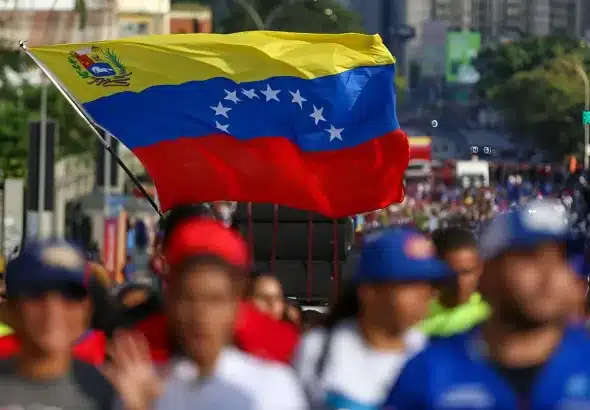 A big Venezuelan flag being waved by a marcher in Caracas demanding United Nations to prevent a US military aggression against Venezuela, October 6, 2025. File photo.
