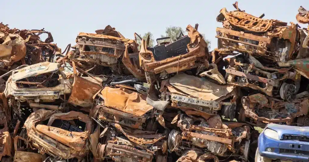 Burned-out vehicles at Moshav Tkuma last September, 2024. A temporary memorial site for the squatter's colony. Photo: Ilan Assayag/Haaretz.