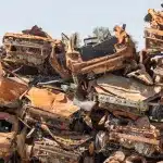 Burned-out vehicles at Moshav Tkuma last September, 2024. A temporary memorial site for the squatter's colony. Photo: Ilan Assayag/Haaretz.