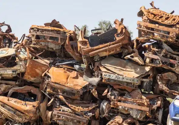 Burned-out vehicles at Moshav Tkuma last September, 2024. A temporary memorial site for the squatter's colony. Photo: Ilan Assayag/Haaretz.