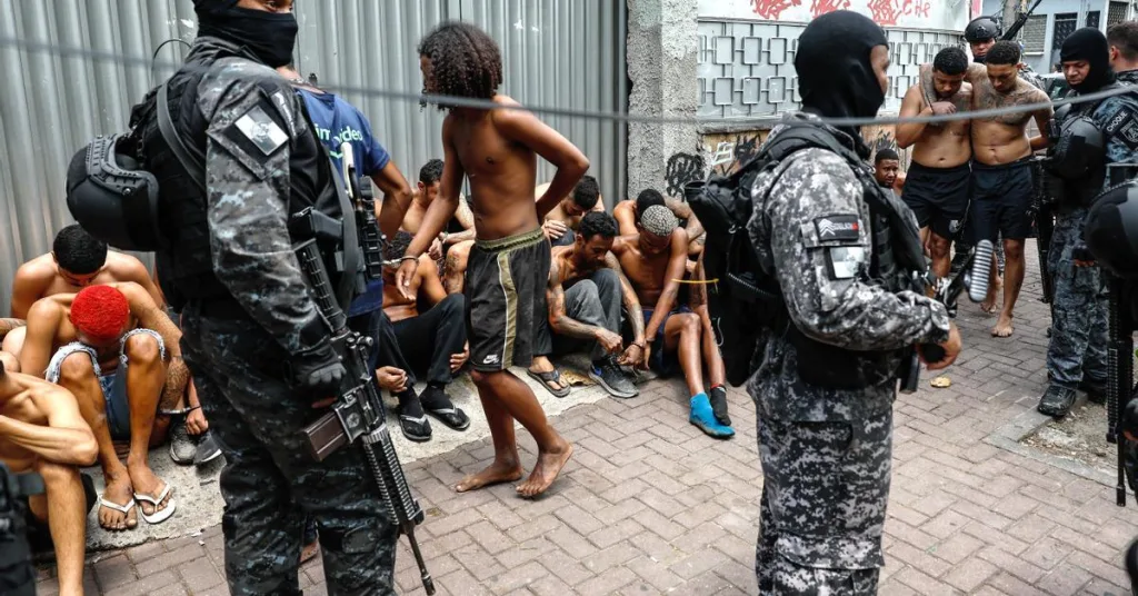 A photo from the operation showing detained individuals and police. Photo: EFE.