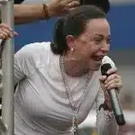 Venezuelan opposition leader María Corina Machado speaks into a microphone at a public event. Photo: Codepink.