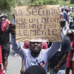 A protester holds up a sign that reads in French, "Security is a right, Haiti deserves it" during a demonstration in Port-au-Prince, Haiti, April 2, 2025. Photo: Odelyn Joseph/AP.