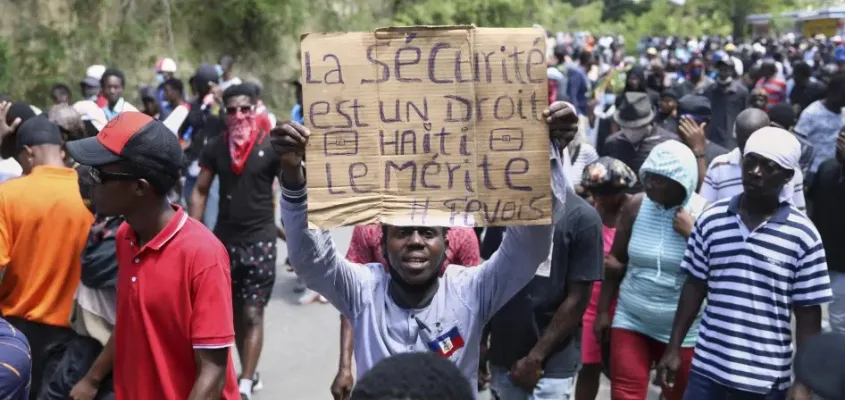 A protester holds up a sign that reads in French, "Security is a right, Haiti deserves it" during a demonstration in Port-au-Prince, Haiti, April 2, 2025. Photo: Odelyn Joseph/AP.