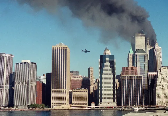 A second plane is seen flying over the city of New York while one of the towers of the World Trade Center is on fire. Photo: Global Delinquents/file photo.