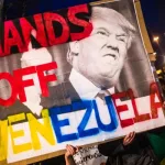 Placard held demanding that US military stop interfering in Venezuela. Source: AP Photo.