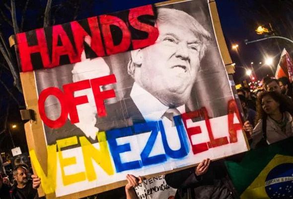Placard held demanding that US military stop interfering in Venezuela. Source: AP Photo.
