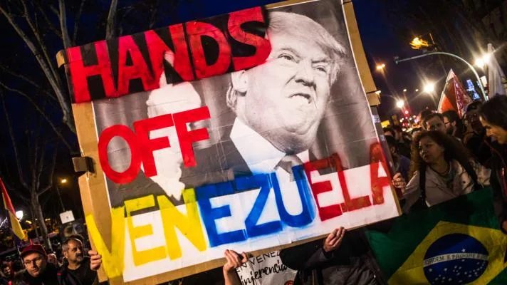 Placard held demanding that US military stop interfering in Venezuela. Source: AP Photo.