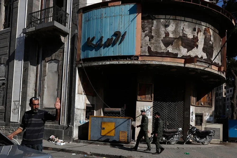 Three men walk through a street in the old city of Homs, Syria. Photo: AP.