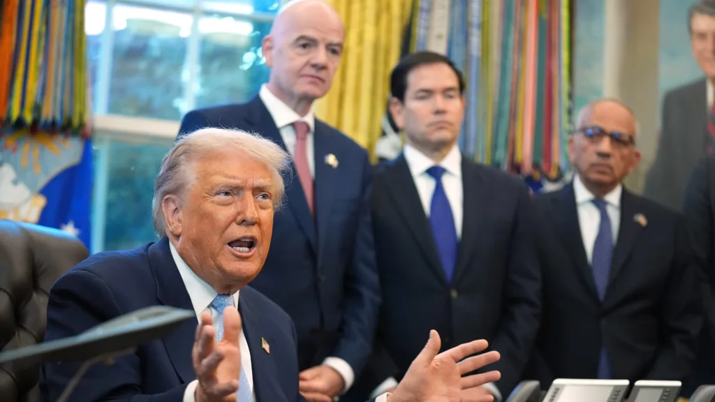 Donald Trump answers questions from reporters during a meeting in the White House Oval Office, Monday, Nov. 17, 2025, as FIFA President Gianni Infantino, Secretary of State Marco Rubio, and FIFA Senior Adviser Carlos Cordeiro listen. Photo: Evan Vucci/AP.