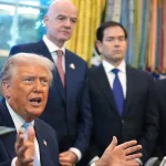 Donald Trump answers questions from reporters during a meeting in the White House Oval Office, Monday, Nov. 17, 2025, as FIFA President Gianni Infantino, Secretary of State Marco Rubio, and FIFA Senior Adviser Carlos Cordeiro listen. Photo: Evan Vucci/AP.