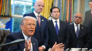 Donald Trump answers questions from reporters during a meeting in the White House Oval Office, Monday, Nov. 17, 2025, as FIFA President Gianni Infantino, Secretary of State Marco Rubio, and FIFA Senior Adviser Carlos Cordeiro listen. Photo: Evan Vucci/AP.
