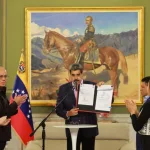 Venezuelan President Nicolás Maduro holds up the signed Law of the Command for the Integral Defense of the Nation, in Miraflores Palace, Caracas, November 11, 2025. Photo: Con El Mazo Dando.