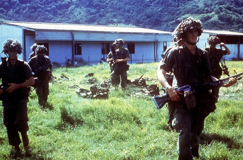 Members of the US 82nd Airborne Division prepare to go out on patrol during Operation Urgent Fury in Grenada, 1982. Two soldiers have M203 40 mm grenade launchers mounted on M16A1 rifles. Photo: Wikimedia Commons.