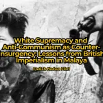 A wounded man is held at gunpoint by British forces in Malaya. Photo: Ministry of Information.