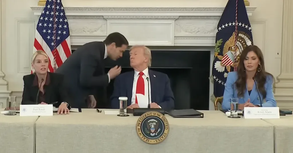 This image captures a moment during a White House roundtable event where Marco Rubio, the US Secretary of State, whispered in President Donald Trump's ear after handing him a note. October 2025. Photo: Screenshot of White House footage.