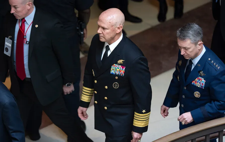 US Navy Admiral Frank ‘Mitch’ Bradley (centre) commander of the US Special Operations Command, and General Dan Caine, chairman of the Joint Chiefs of Staff (right) are escorted to a classified briefing, Dececmber 4, 2025. Photo: J. Scott Applewhite/AP.