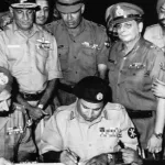 Signing of Pakistani Instrument of Surrender by Pakistan's Lt.Gen. A. A. K. Niazi to the Joint Commander of the Liberation Force Lt. Gen. Jagjit Singh Aurora in Dhaka on 16 Dec' 1971. Photo: Wikimedia Commons.