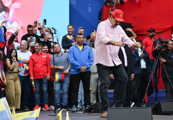 Venezuelan President Nicolás Maduro dancing a rap version of his recent calls for peace in English that has become viral in Venezuela, during a massive rally of support in Caracas on Monday, December 1, 2025. Photo: AFP.