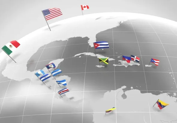 3D illustration of a globe focusing on North and Central America, displaying various national flags such as the United States, Canada, Mexico, Cuba, Jamaica, Haiti, the Dominican Republic, Puerto Rico, Belize, Guatemala, El Salvador, Honduras, Nicaragua, Costa Rica, Panama, and Venezuela. Photo: Alamy.