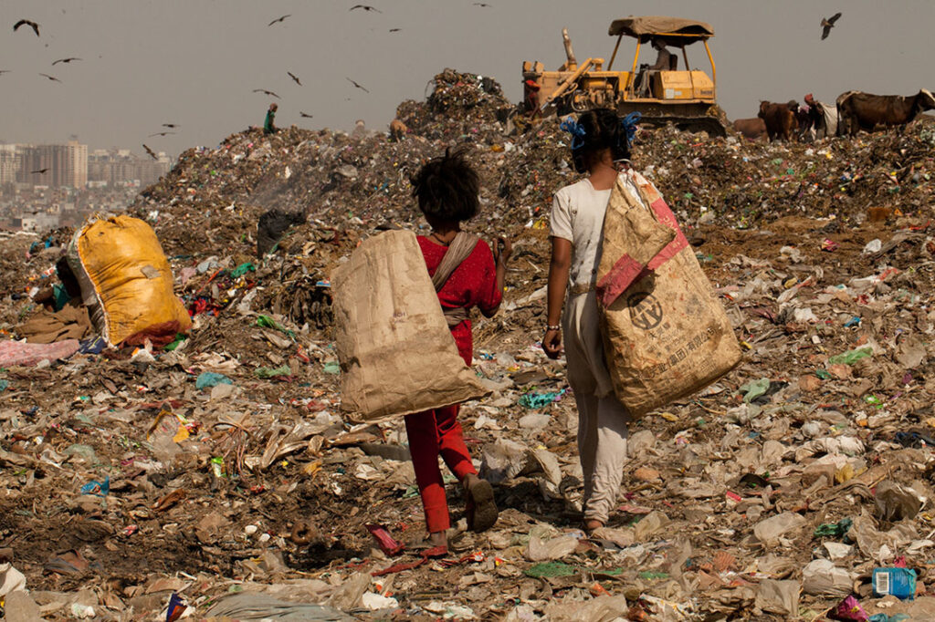 Children walking in a landfill. File photo.