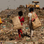 Children walking in a landfill. File photo.