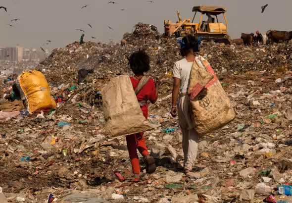 Children walking in a landfill. File photo.