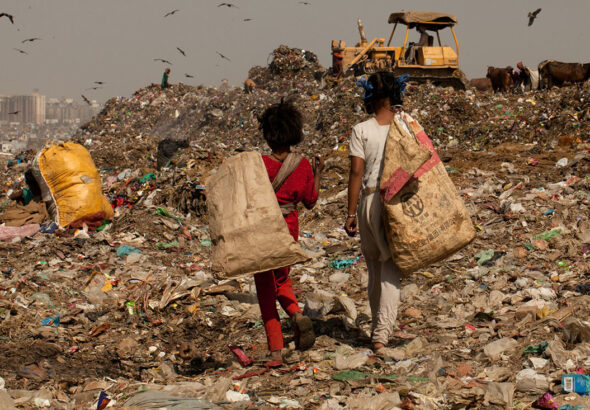 Children walking in a landfill. File photo.
