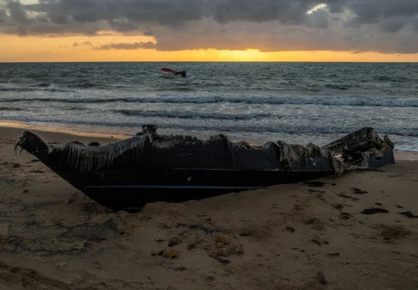 Remains of a burned boat on the beach, near Puerto López on the Guajira Peninsula in Colombia. Photo: Federico Rios/New York Times.