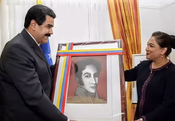 Then-Prime Minister of Trinidad and Tobago, Kamla Persad-Bissessar, received a portrait of Simón Bolívar from the President of Venezuela, Nicolás Maduro in 2015. Photo: Wired 868/file photo.