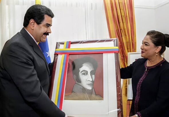 Then-Prime Minister of Trinidad and Tobago, Kamla Persad-Bissessar, received a portrait of Simón Bolívar from the President of Venezuela, Nicolás Maduro in 2015. Photo: Wired 868/file photo.