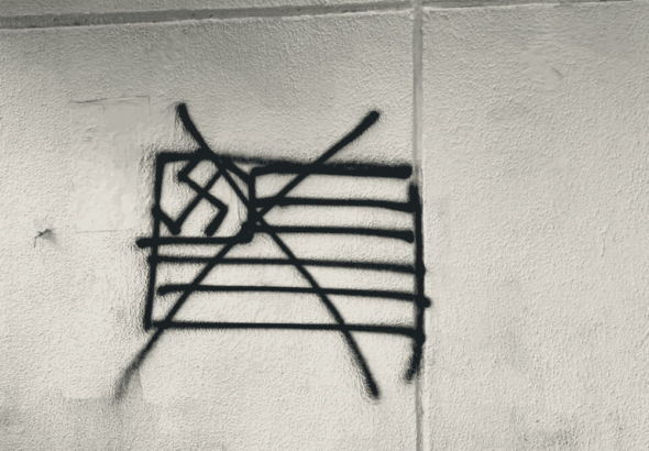 Graffiti in Mexico City showing a crossed-out US flag with a swastika. Photo: Camilo Ocampo.