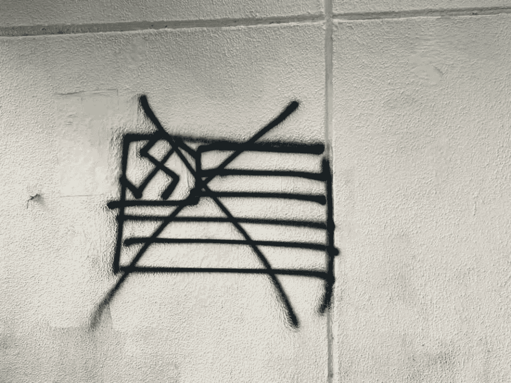 Graffiti in Mexico City showing a crossed-out US flag with a swastika. Photo: Camilo Ocampo.