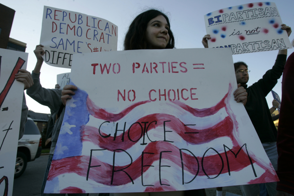 Cornell University student Marielle Newsome, of College Libertarians, holds in a demonstration a banner that reads “Two parties=No choice, Choice=Freedom, on Sept. 26, 2006, at Cornell University in Ithaca, NY. Photo: David Duprey/AP.