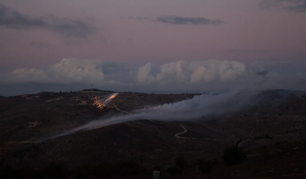 Artillery fire from an Israeli position hits the hills near the outskirts of the border town of Odaisseh in southern Lebanon. Photo: Hasan Fneich/AFP/Getty Images.
