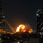 Fire and smoke rise in Tel Aviv following the impact of an Iranian missile fired in response to US-Israeli aggression, February 28, 2026. Photo: Chaim Goldberg/Flash90.