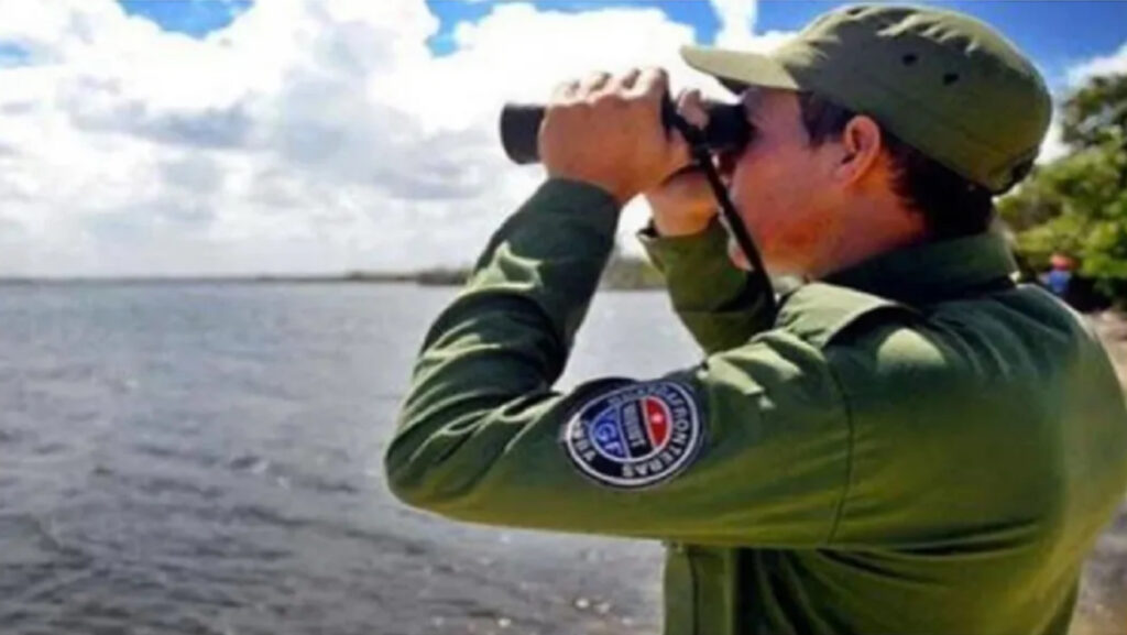 A member of the Cuban Border Guard observes the sea with his binoculars. File photo.