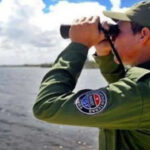 A member of the Cuban Border Guard observes the sea with his binoculars. File photo.